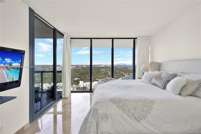 bedroom featuring access to exterior and floor to ceiling windows