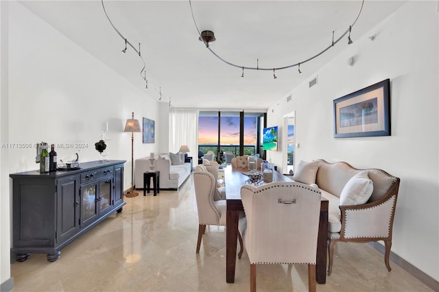 dining space featuring a wall of windows