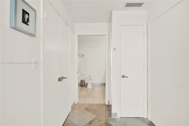 hall with light tile patterned flooring