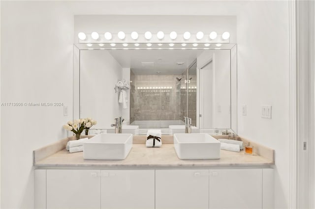 bathroom with vanity and bath / shower combo with glass door