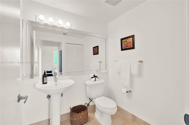 bathroom featuring tile patterned flooring and toilet