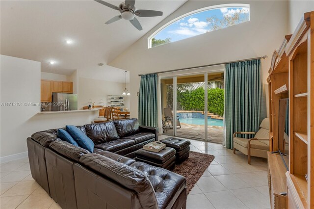 tiled living room featuring a towering ceiling and ceiling fan