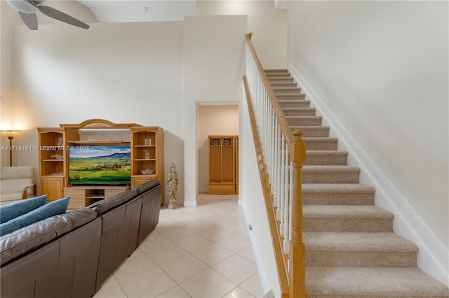 staircase with tile patterned floors and ceiling fan