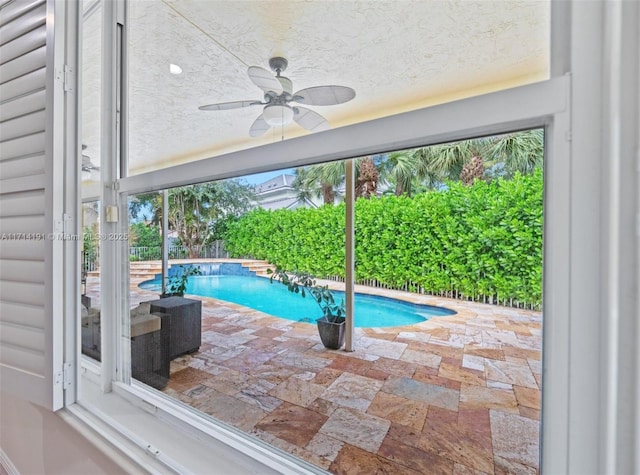 view of pool with a patio and ceiling fan