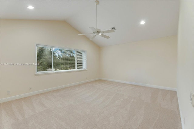 unfurnished room featuring ceiling fan, lofted ceiling, and light carpet