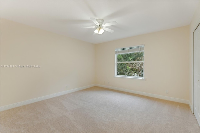 carpeted empty room featuring ceiling fan