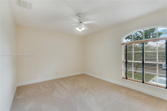 carpeted empty room featuring ceiling fan