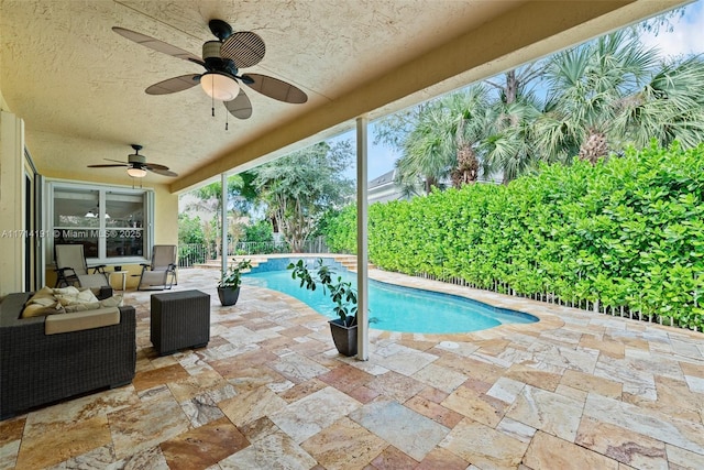 view of pool featuring ceiling fan and a patio