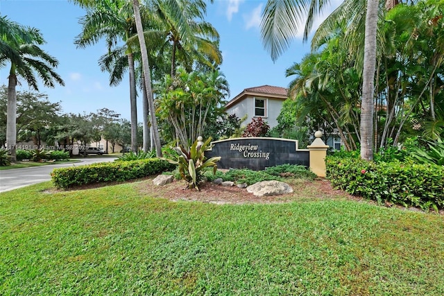 community sign featuring a lawn