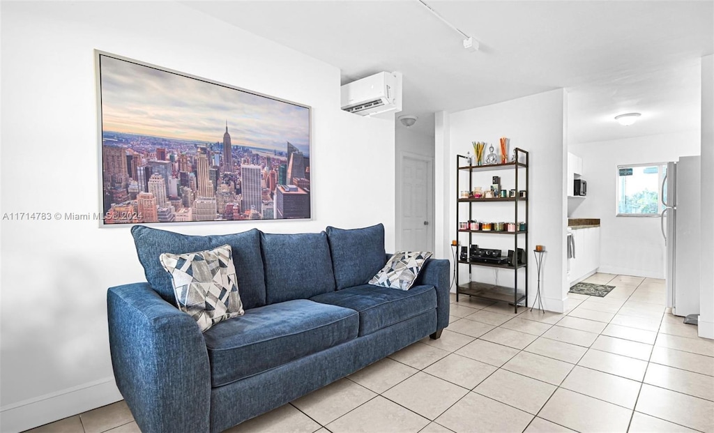 living room featuring light tile patterned floors and a wall mounted AC