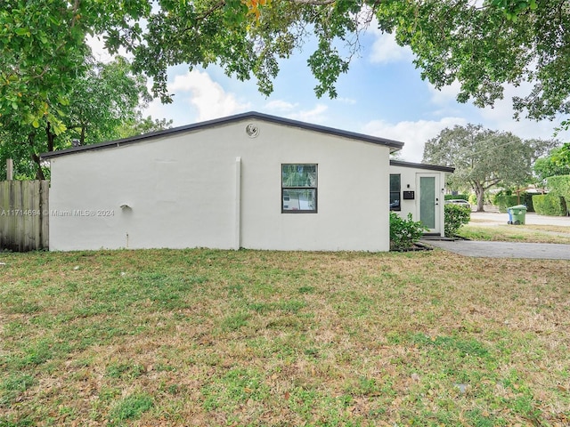 view of home's exterior with a yard