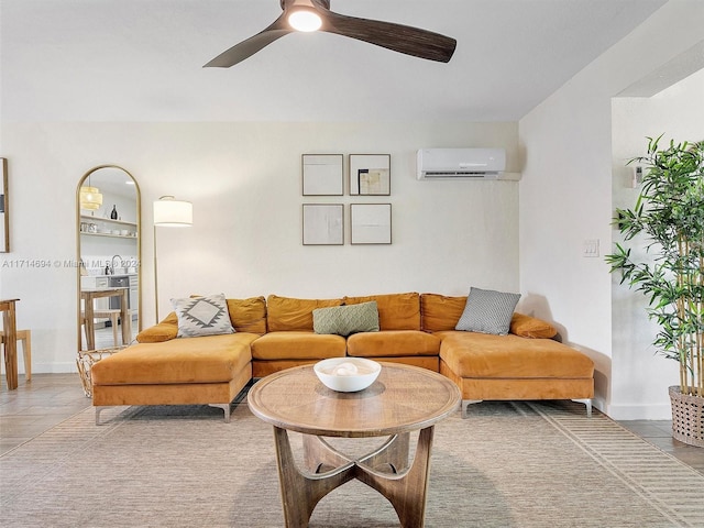 living room with tile patterned flooring, ceiling fan, and a wall mounted AC