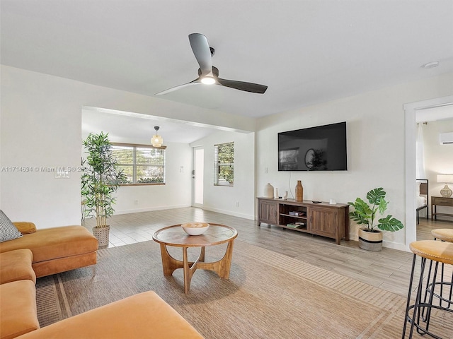 living room with ceiling fan and lofted ceiling