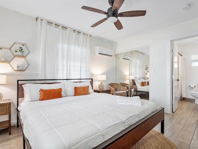 bedroom featuring ceiling fan, ensuite bathroom, and a wall mounted AC