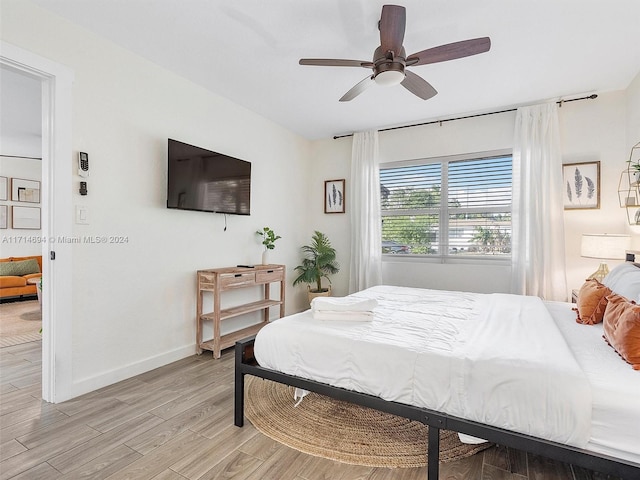 bedroom featuring light hardwood / wood-style floors and ceiling fan