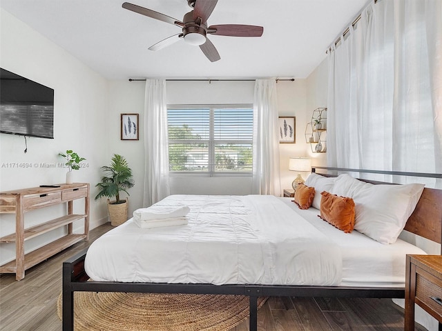 bedroom with hardwood / wood-style flooring and ceiling fan