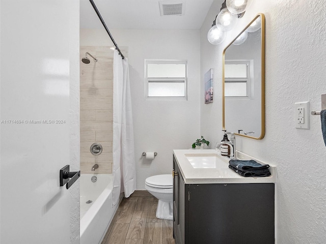 full bathroom with shower / bath combination with curtain, toilet, and vanity