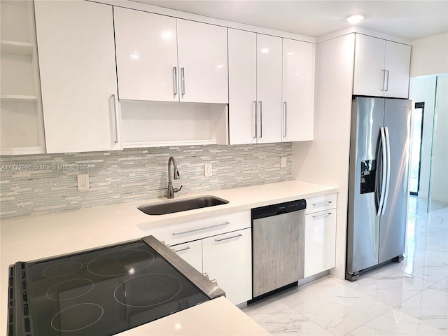 kitchen featuring white cabinets, decorative backsplash, sink, and appliances with stainless steel finishes