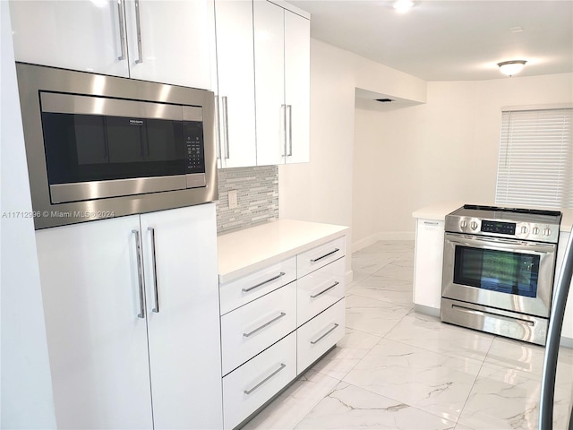 kitchen featuring backsplash, white cabinetry, and stainless steel appliances