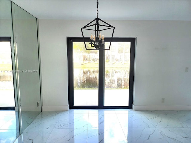 unfurnished dining area with a chandelier