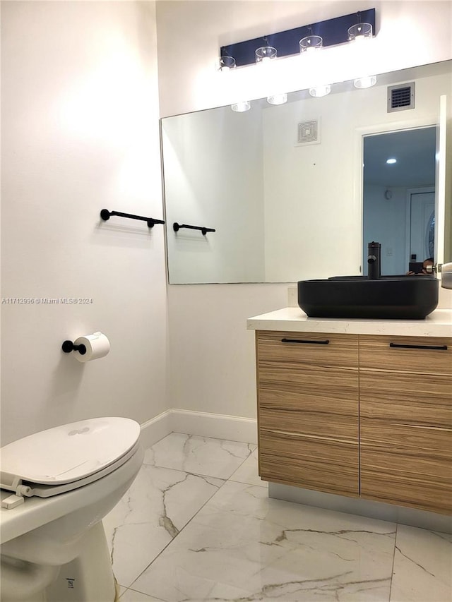 bathroom with vanity and toilet