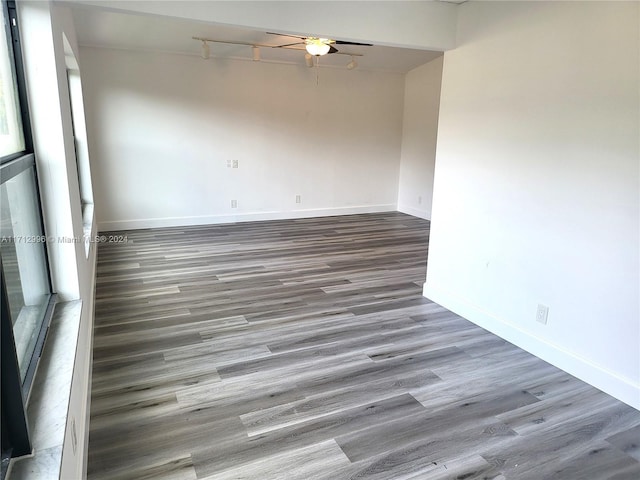 spare room featuring ceiling fan and dark hardwood / wood-style flooring