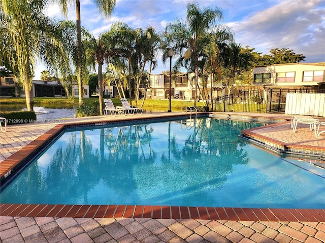 view of swimming pool featuring a water view