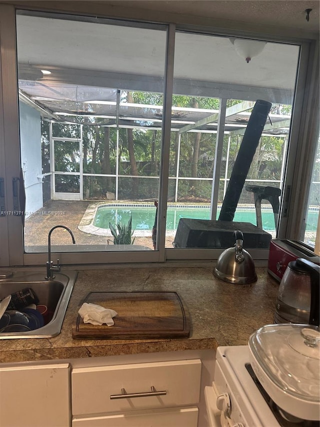 interior details featuring sink and white cabinets