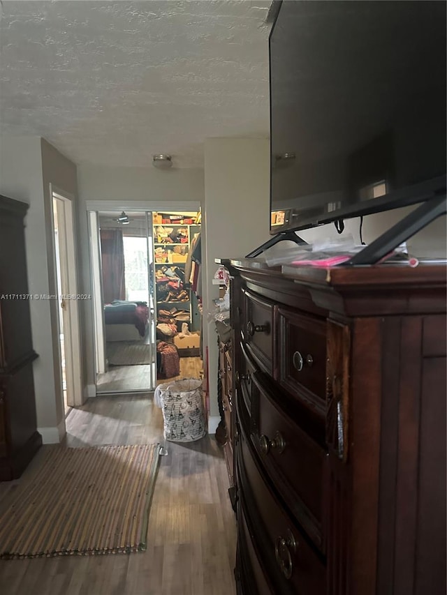 bedroom featuring a textured ceiling and hardwood / wood-style flooring