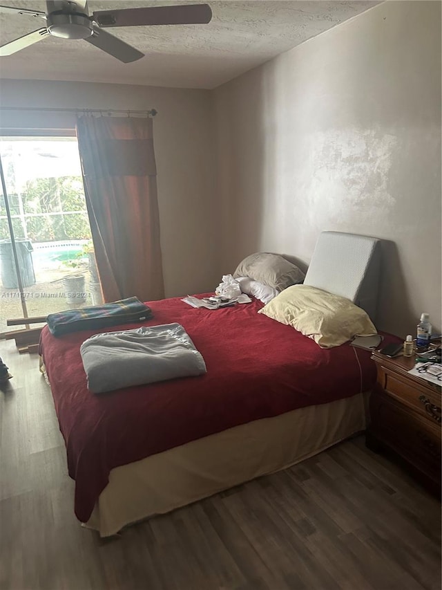 bedroom with ceiling fan, a textured ceiling, and hardwood / wood-style flooring