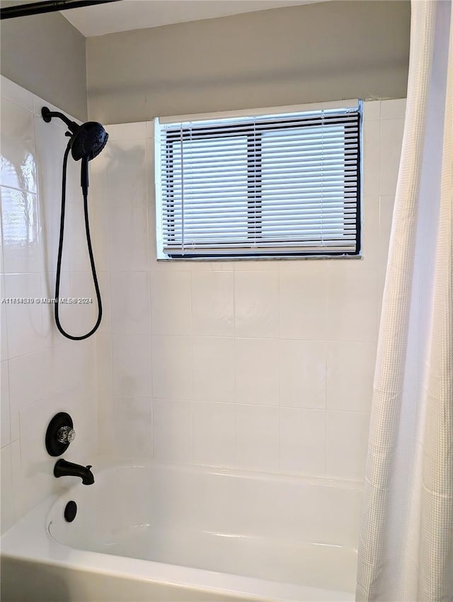 bathroom with shower / tub combo with curtain