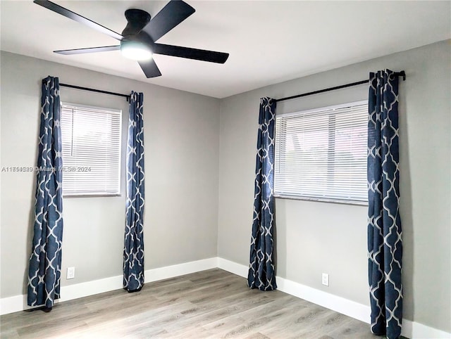 spare room with ceiling fan and wood-type flooring