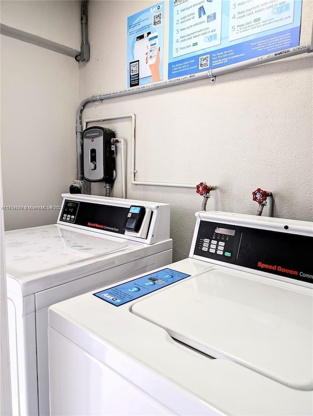 clothes washing area with washer and dryer