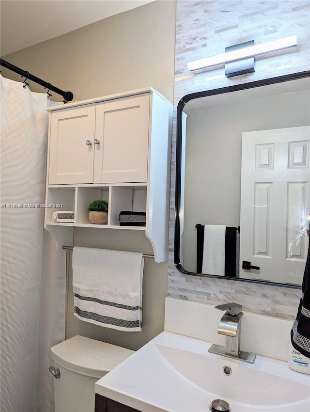 bathroom featuring vanity, a shower with shower curtain, and toilet