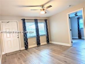 empty room with ceiling fan and wood-type flooring