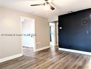 empty room with hardwood / wood-style flooring and ceiling fan