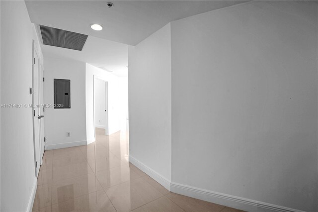 corridor featuring light tile patterned floors and electric panel