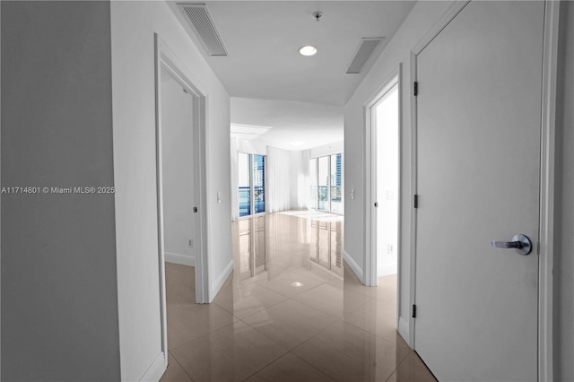 hallway with recessed lighting, visible vents, and baseboards