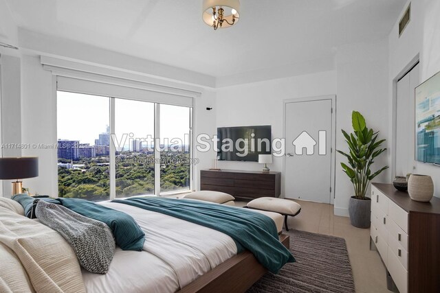 60 SW 13th St Unit 1700, Miami, FL 33130 - bedroom with light tile patterned floors and a city view