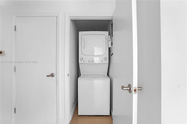 clothes washing area featuring laundry area and stacked washer / drying machine