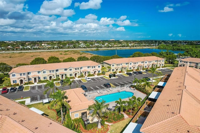 drone / aerial view featuring a water view and a residential view