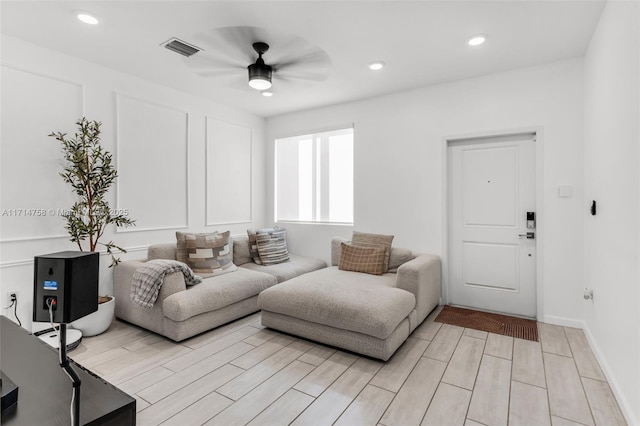 living area featuring wood finish floors, visible vents, ceiling fan, and recessed lighting