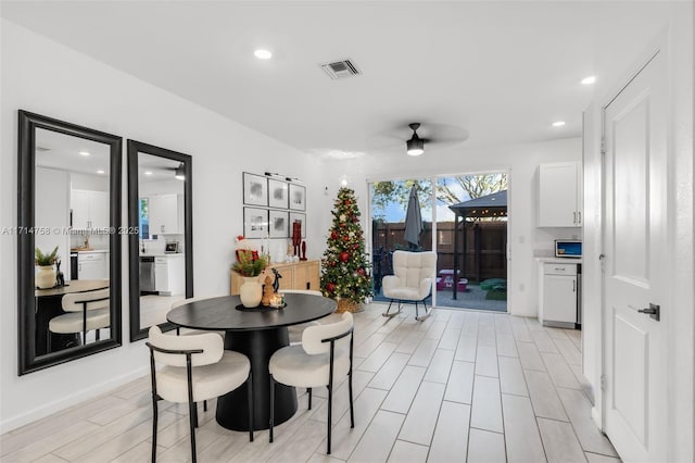 dining room featuring wood tiled floor, visible vents, ceiling fan, and recessed lighting