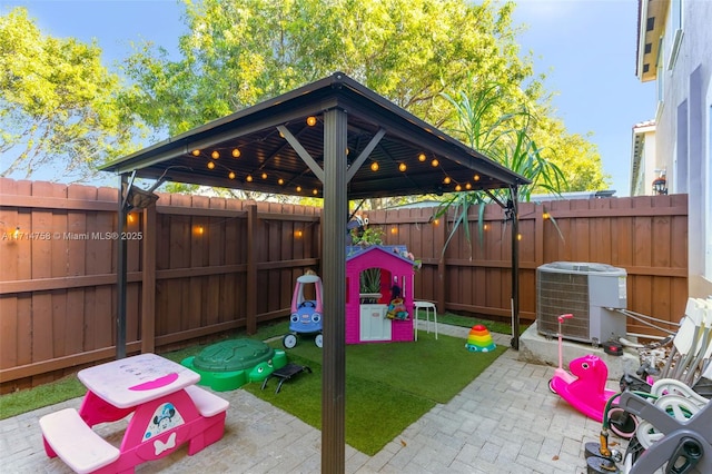 view of jungle gym with a lawn, a patio area, a fenced backyard, and central air condition unit