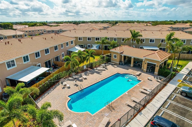 pool with a gazebo, a patio area, fence, and a residential view