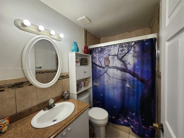 bathroom featuring vanity, backsplash, toilet, tile walls, and walk in shower