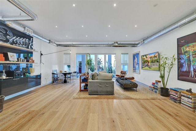 living room with french doors and light wood-type flooring