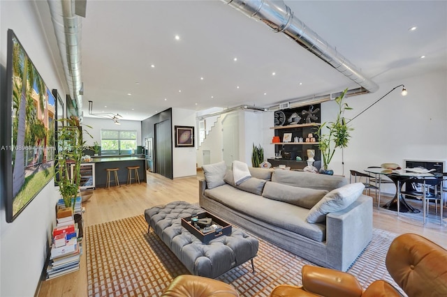 living room with beverage cooler and light wood-type flooring