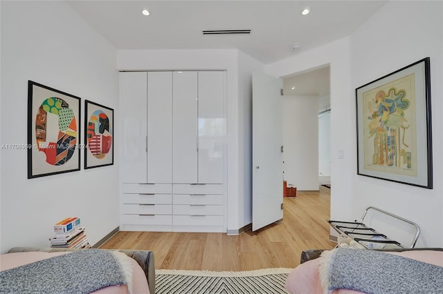 bedroom featuring light wood-type flooring and a closet