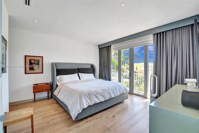 bedroom featuring access to exterior and light wood-type flooring